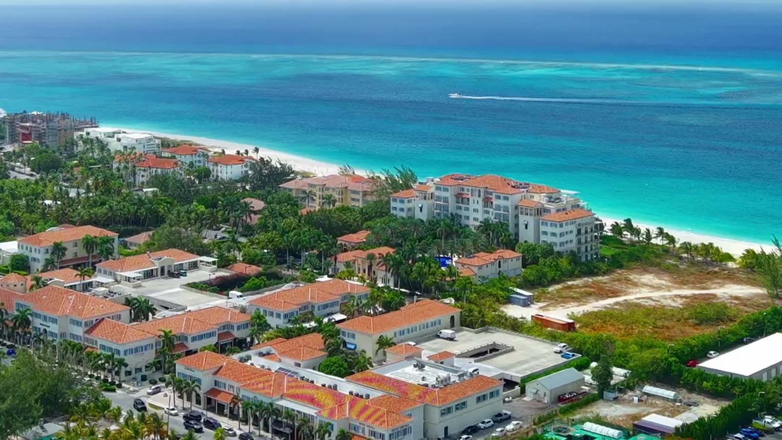Aerial out across Grace Bay from above the store