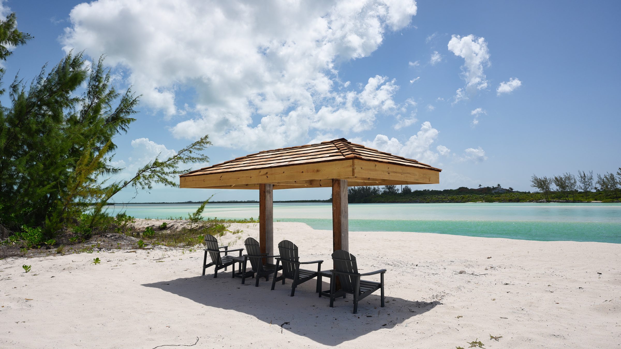 Private beach cabana on white sand beside turquoise water