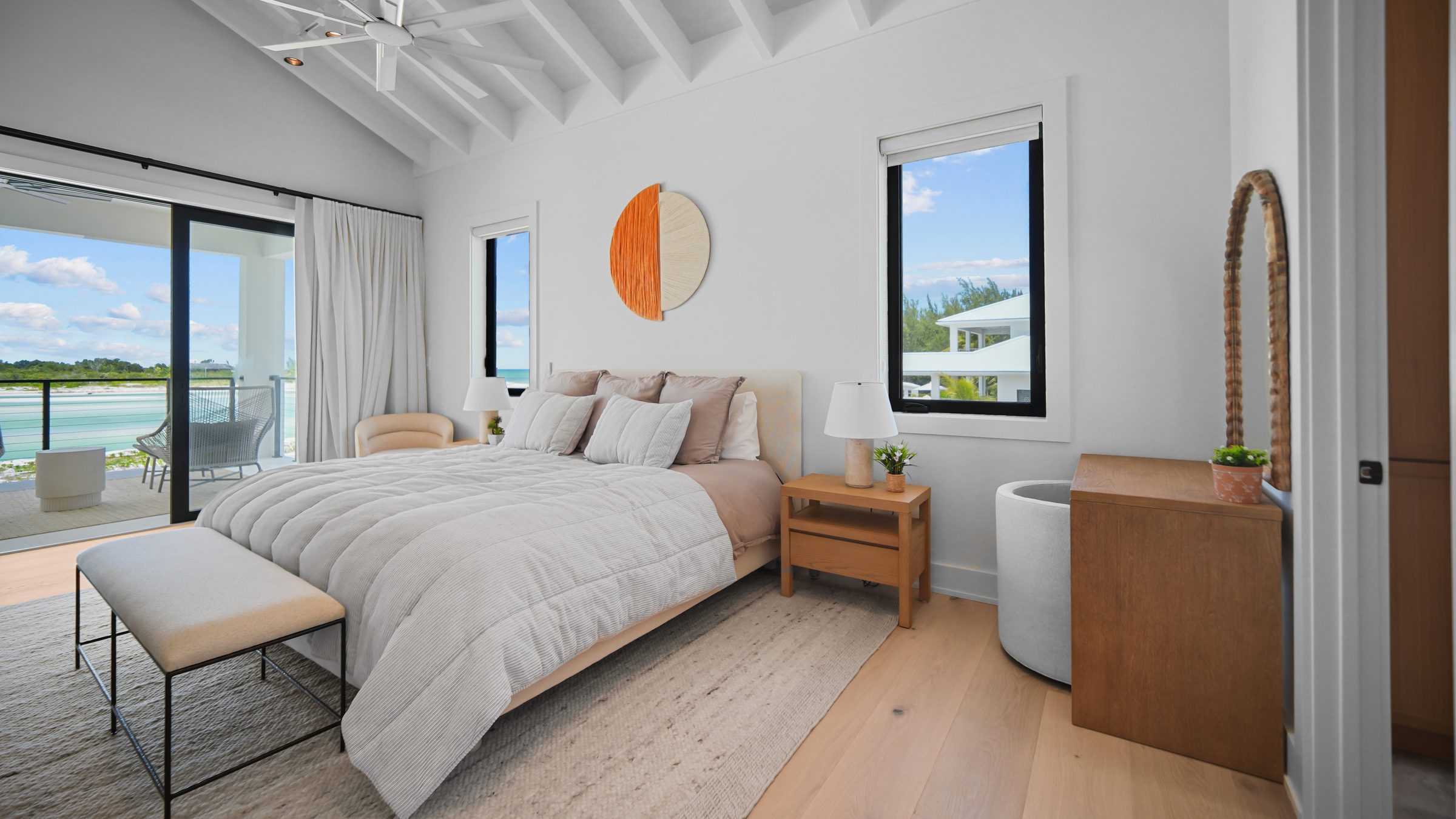 Primary bedroom with vaulted ceiling and ocean-view terrace
