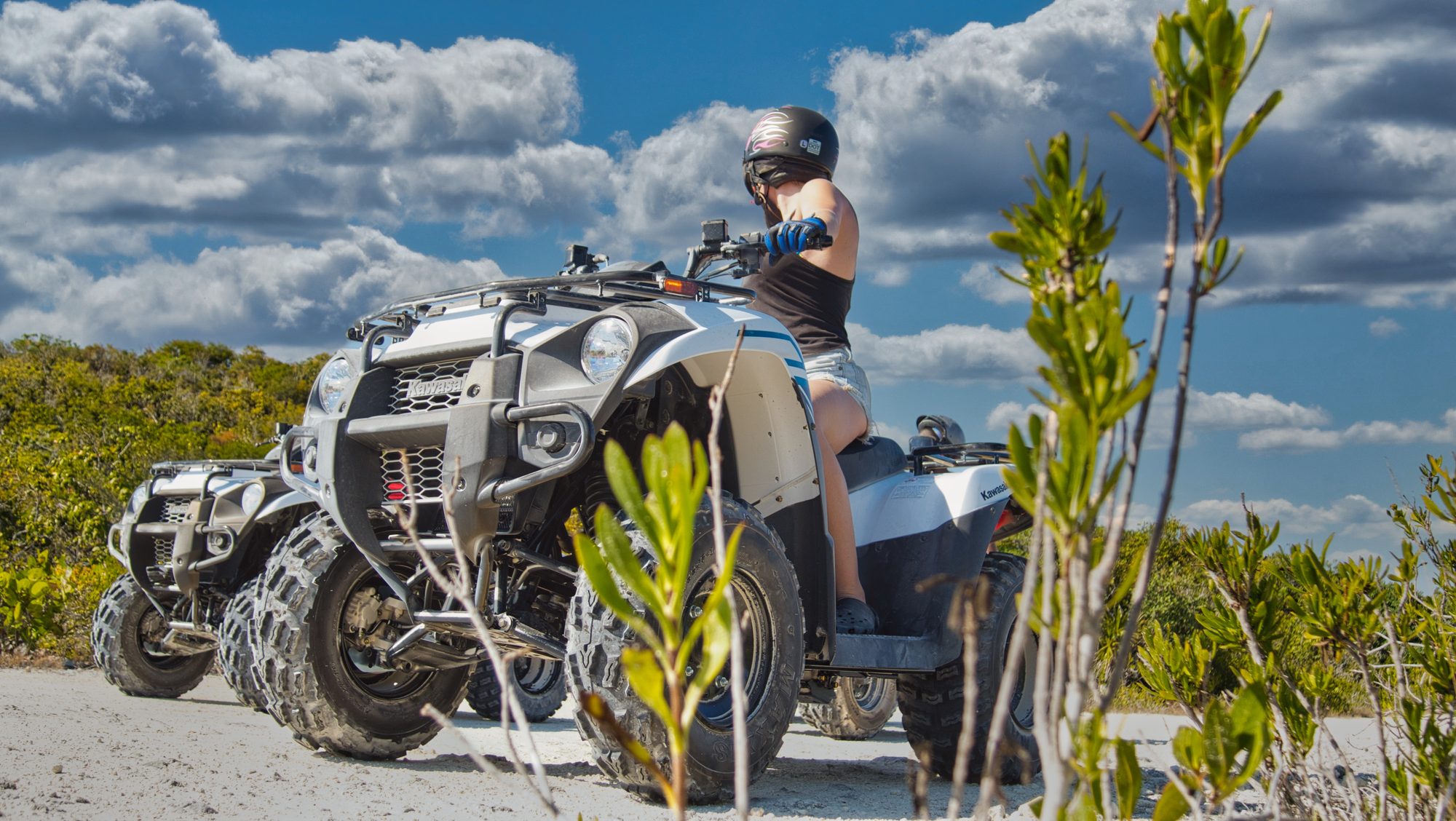 Quad bike tour on a sand track through coastal scrub