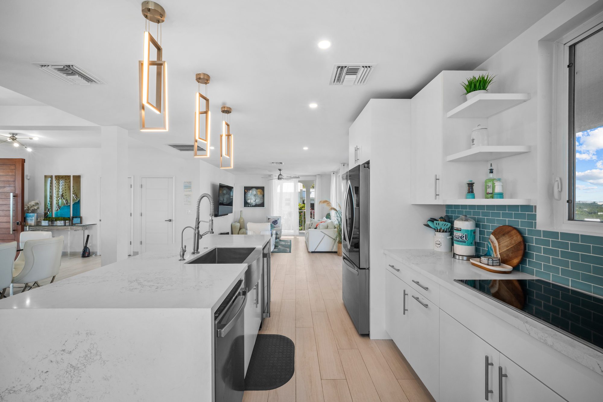 Villa kitchen with teal backsplash and quartz island